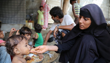 A mother feeds her child. Photo: WFP/Reem Nada
