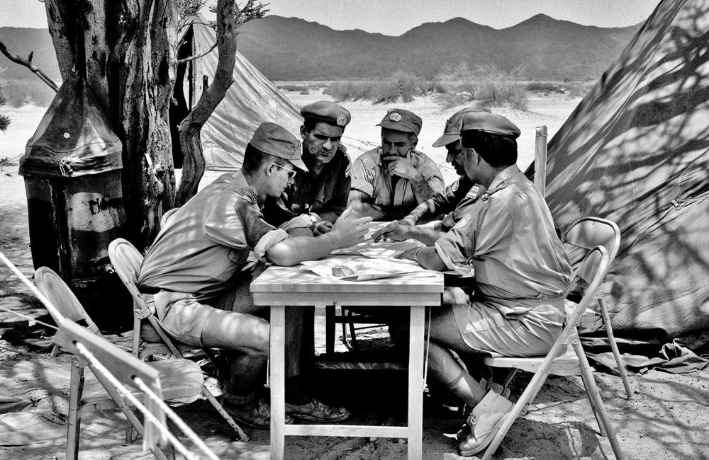 A meeting of the United Nations Yemen Observation Mission (UNYOM). Major Popovic (2nd from left), Commanding Officer of Najran detachment of UNYOM, is seen as he held a meeting at the conclusion of an air patrol.1963. UN Photo/UN Photo Library.