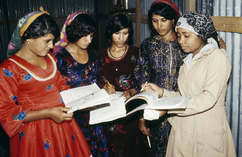 Disadvantaged women worldwide are locked into a lifestyle of exploitation. The Voluntary Fund for the United Nations Decade for Women, established in 1975, is trying to improve their lot through projects implemented on a village level.  Adult literacy class in the El Monhata community centre near Taiz. 1983. UN Photo/UN Photo Library.