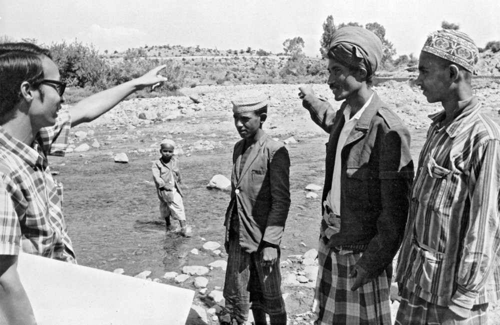 UN Volunteer Yoshikazu Itoh, 28, Japanese irrigation technician, explains to Yemeni farmers benefits they would derive if the irrigation project he is investigating at Wadi Warazan (in southern part of Yemen Arab Republic) materializes. 1972. UN Photo/UN Photo Library.