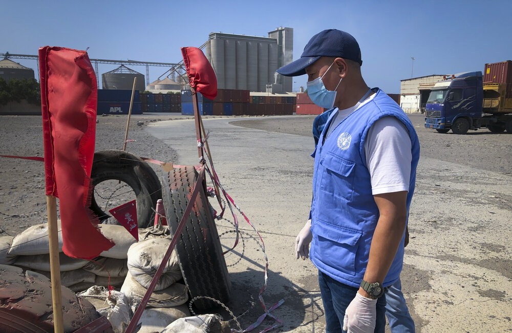 UNMHA personnel inspect markings of an unexploded ordnance site at Hudaydah Port in January 2021. UN Photo/Amanda Fisher.