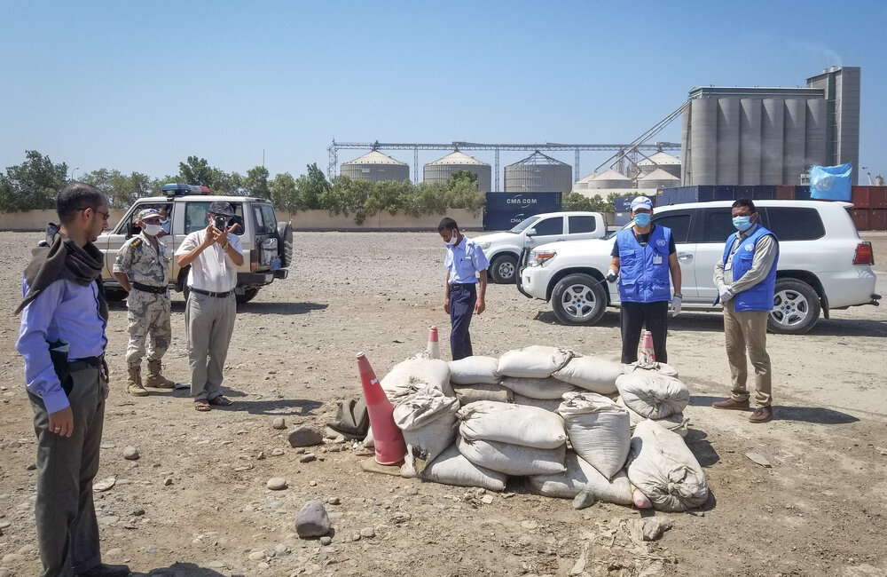 UNMHA personnel looking at markings of an unexploded ordnance site while on a patrol to Hudaydah Port in October 2020. UN Photo/UNMHA.