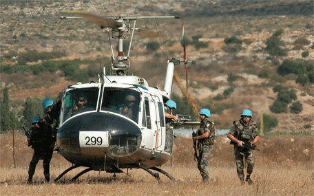 Peacekeepers disembark a helicopter.